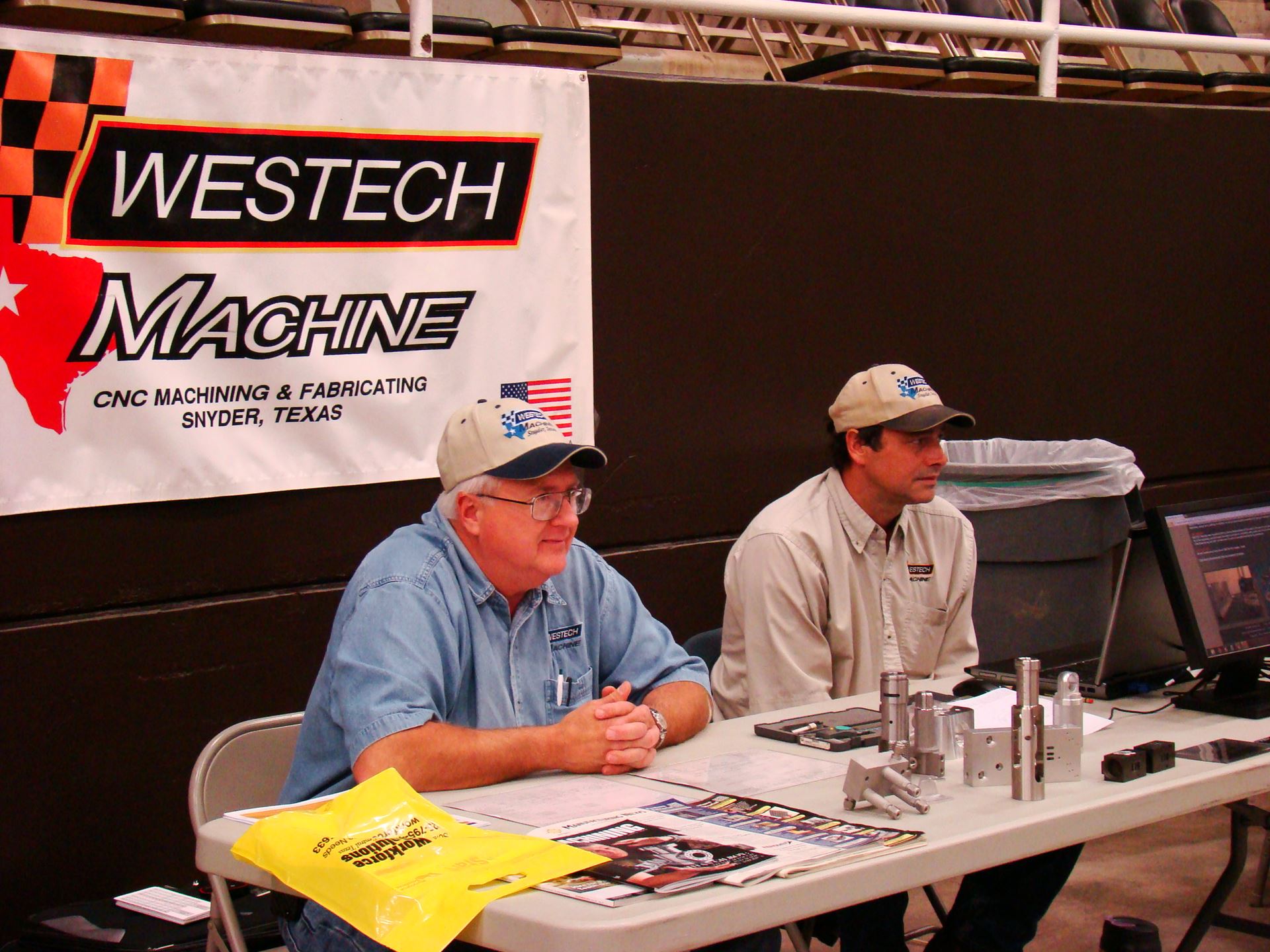 Individuals at Westech booth.